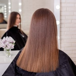 female-back-with-long-straight-brunette-hair-hairdressing-salon-scaled